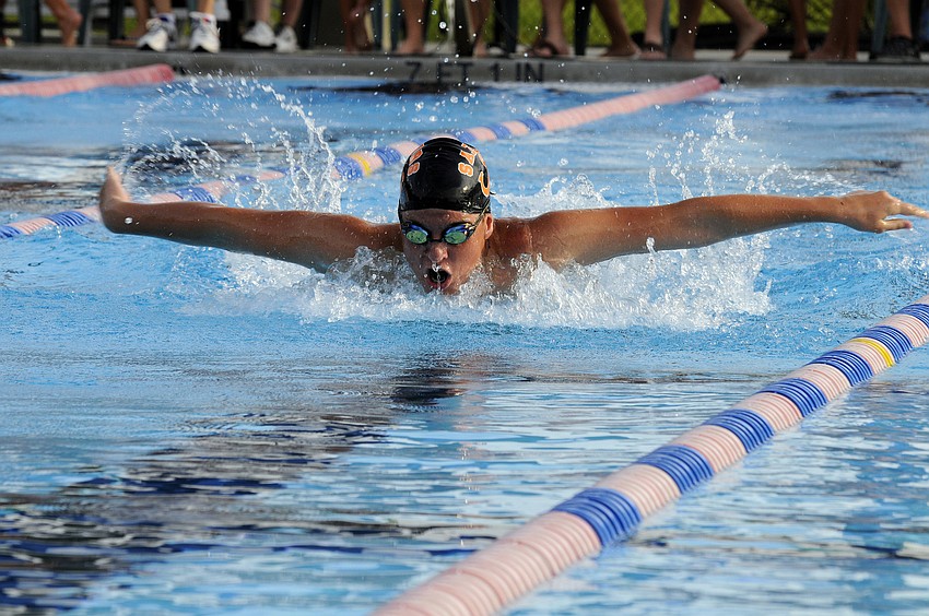 Sarasota Highâ€™s Graham Devitt races down the lane at the start of the boys 200 IM.