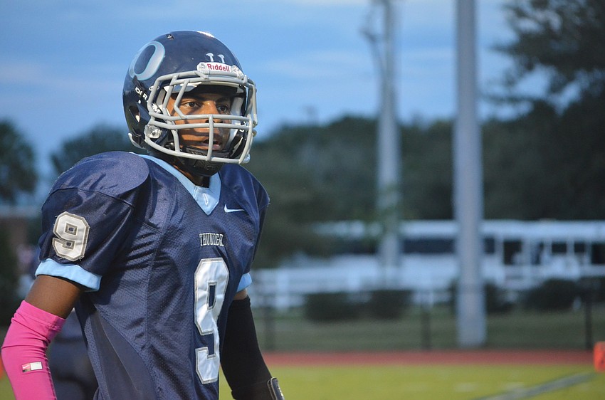 Wide receiver and defensive back David Grain gets direction from the coaches.