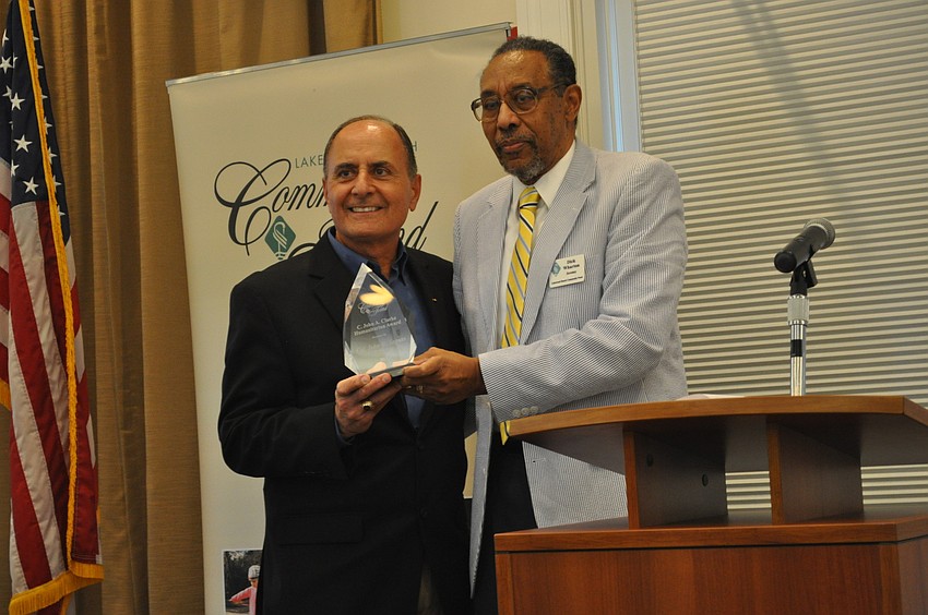Colonel John W. Saputo, president/owner of Gold Coast Eagle Distributing and former Marine, accepted the 2013 C. John A. Clarke Humanitarian Award from Dr. Richard Wharton.