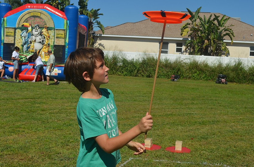 Nicolas Cutler tried plate spinning at the Circus Sarasota booth