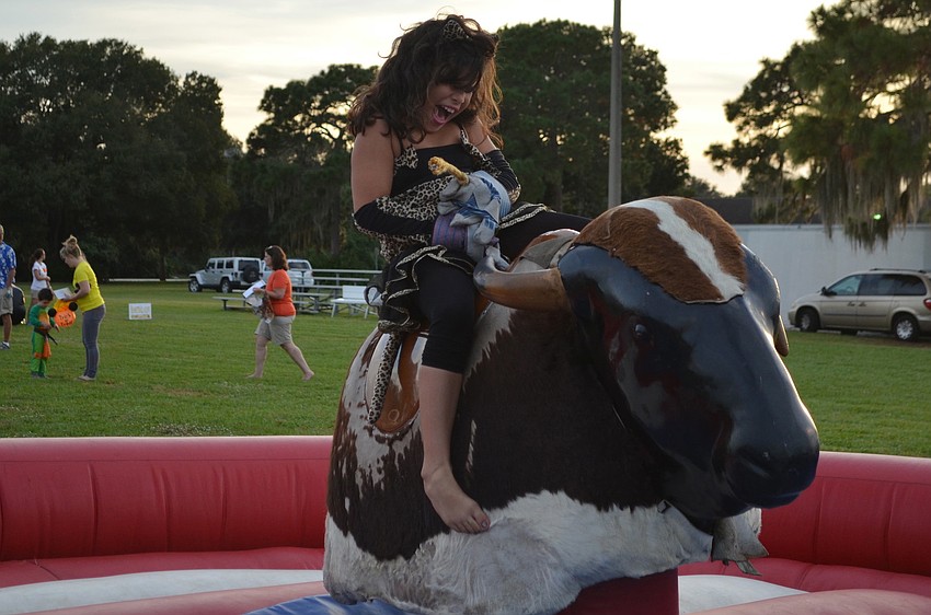 Linda Whitaker rides the mechanical bull.