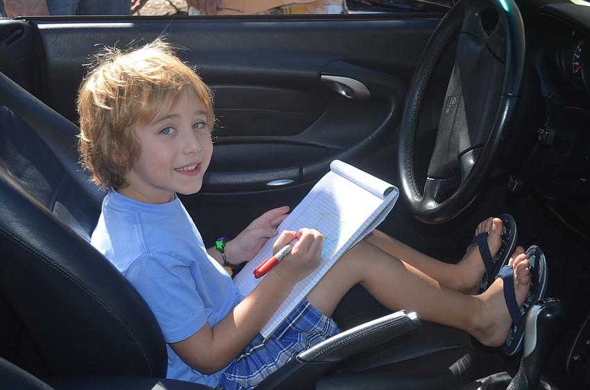 Harrison Williams draws in his dadâ€™s Porsche