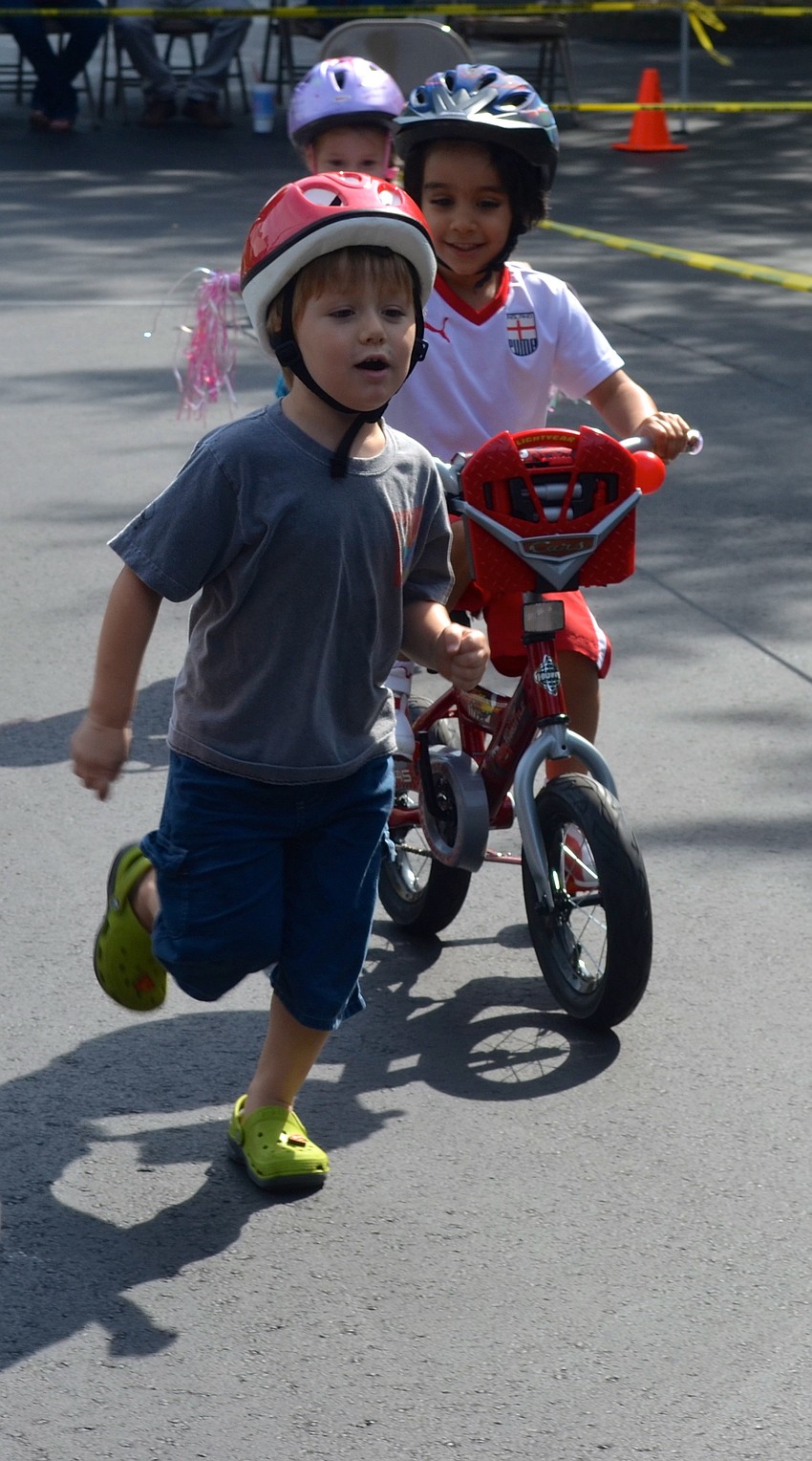 Holden Clark, 3, ditches his scooter and sprints.