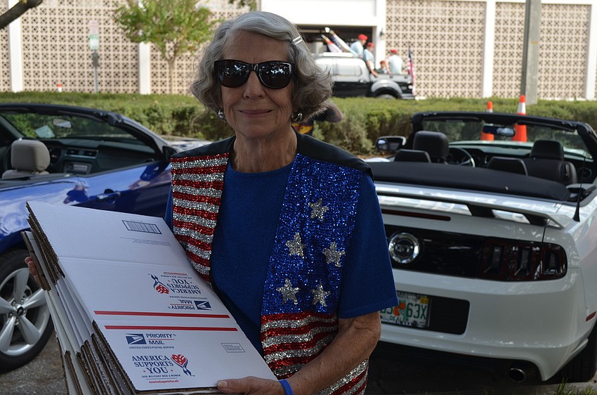 Joyce Hesson hands out care package boxes for those currently serving overseas.