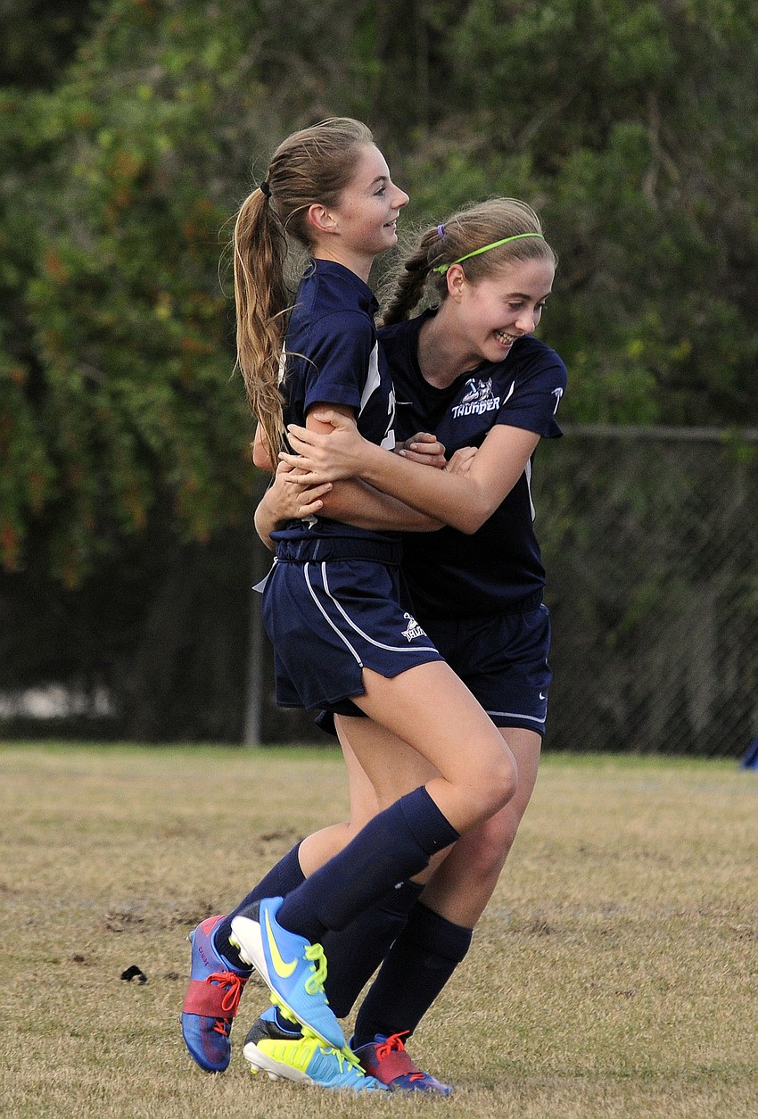 Caitlyn Camire, left, is congratulated by a teammate following her goal in the first half.