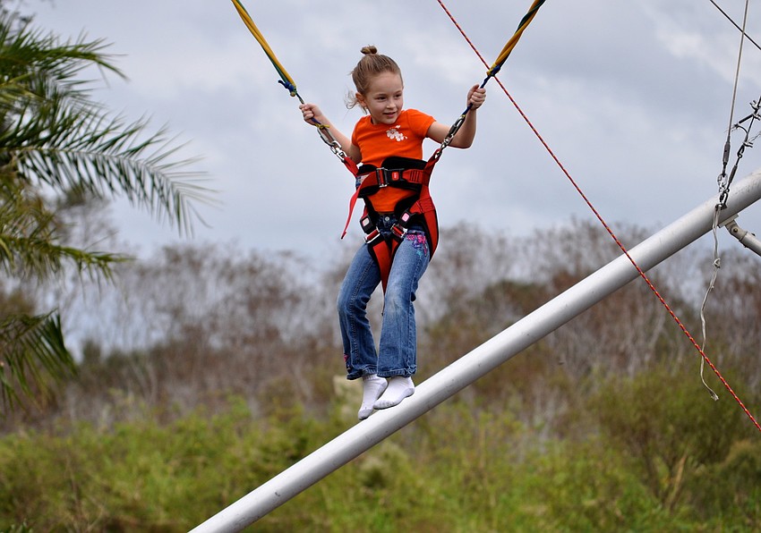 Whitney Britt, 5, flips through the air.