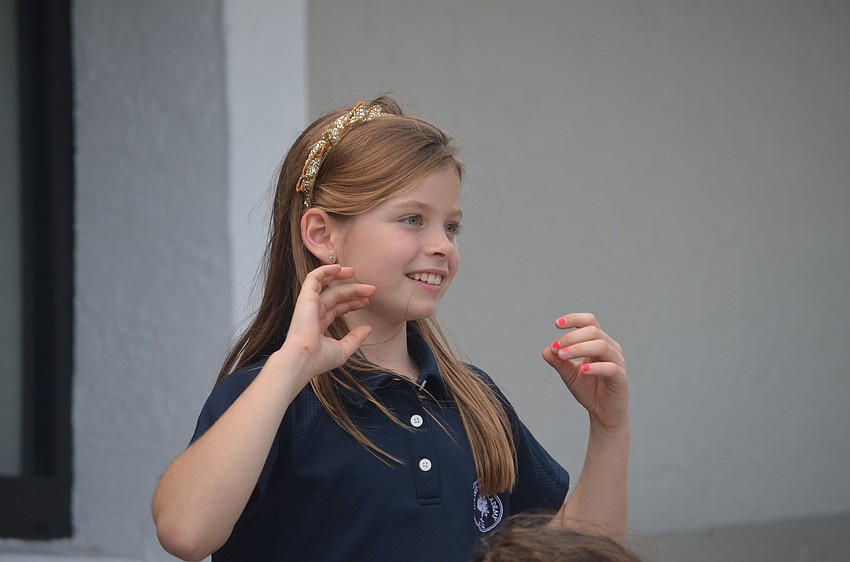 Ella L. watches from the bleachers