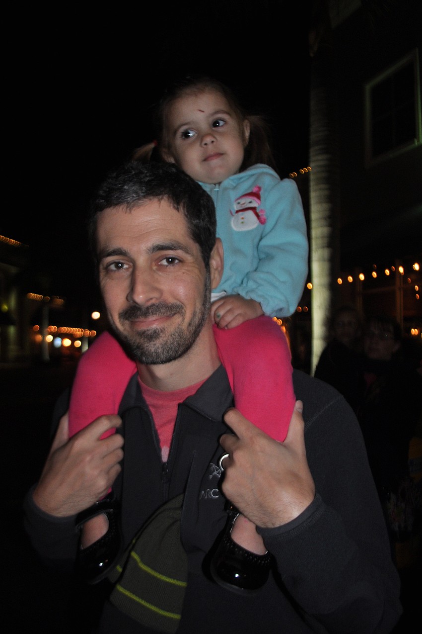 Jason Cobb gives his daughter, Phoebe, a birds-eye view of the ceremony.