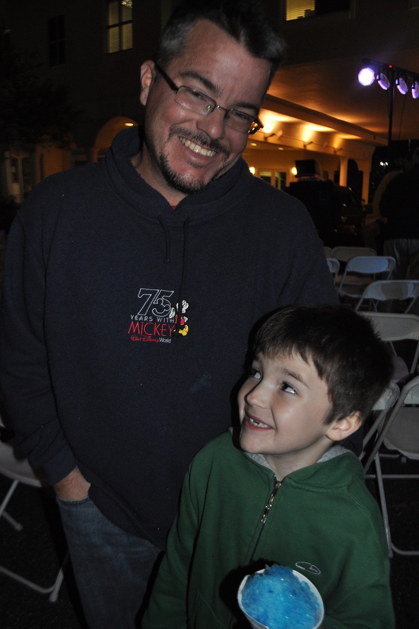Chilly weather doesnâ€™t keep Walker Christensen, pictured with his father, Brian, from eating a snow cone.