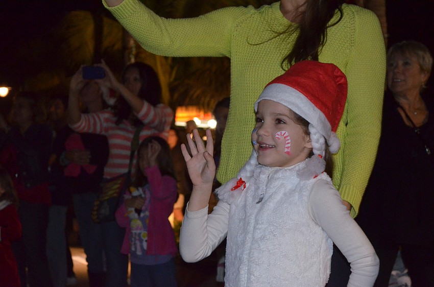 Jadynn Bachman waves to Santa.