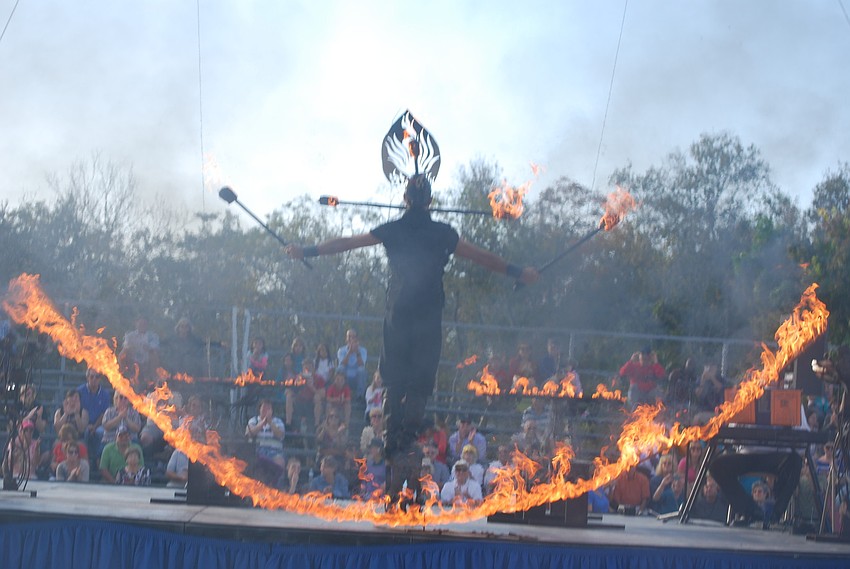 Performer Peter Swarez creates a fire menorah.
