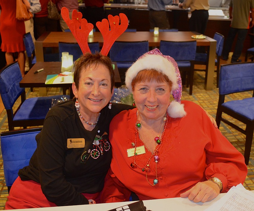 Barbara Zdziarski and Janet Arena welcome party guests.