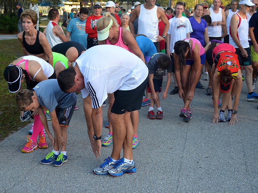 Runners work out their muscles before the start of the race.