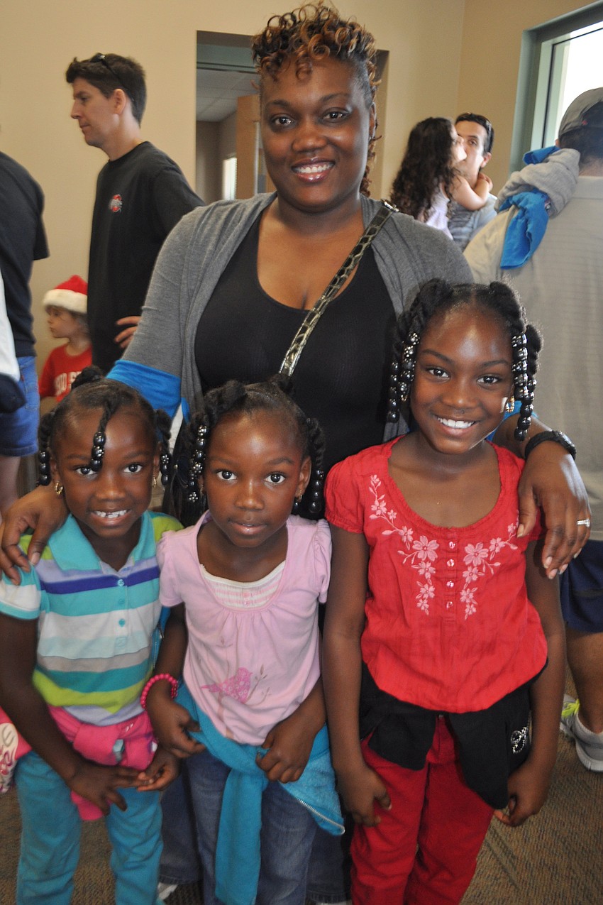 Brandi, Sharde and Zayna Carter wait with their mom, Nichole, to see Santa.