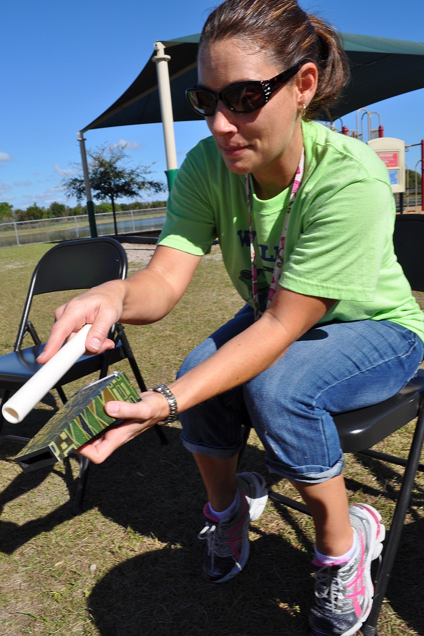 Music teacher Christy Isaacs encourages students to play instruments at the drum circle.
