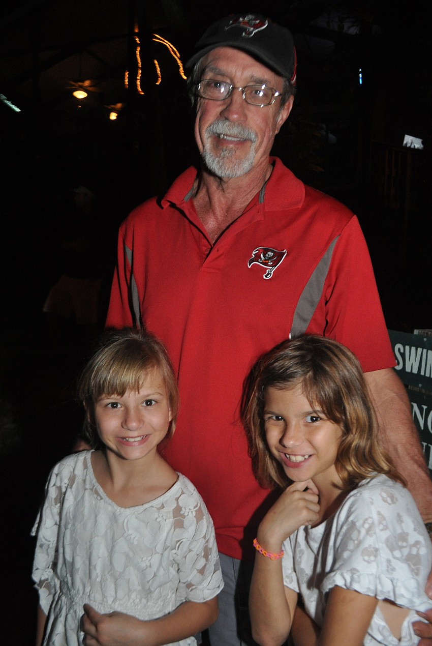 Veronica, Roy and Breana Wells watch the boats come in.