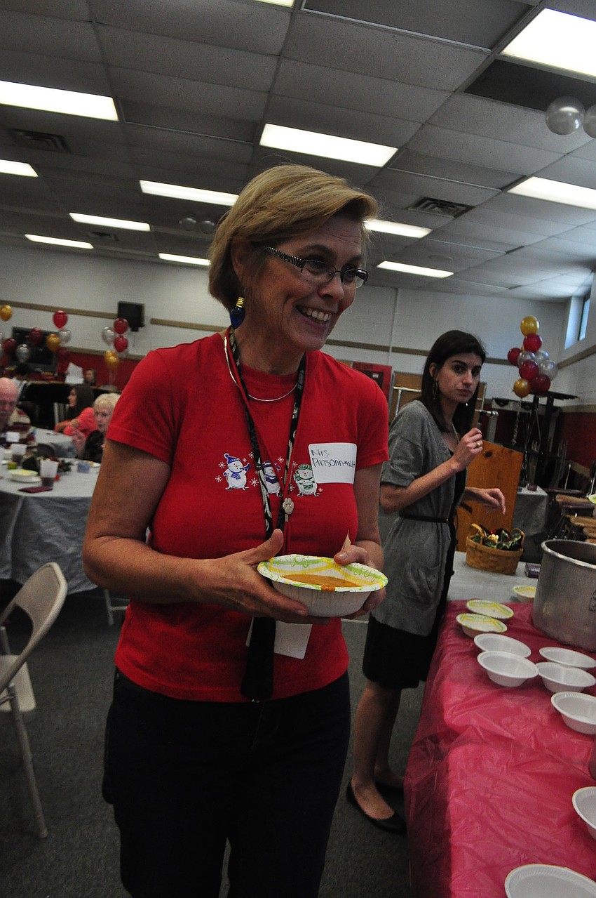 Math teacher Janice Pinsonneault talks with students as she gets her soup.