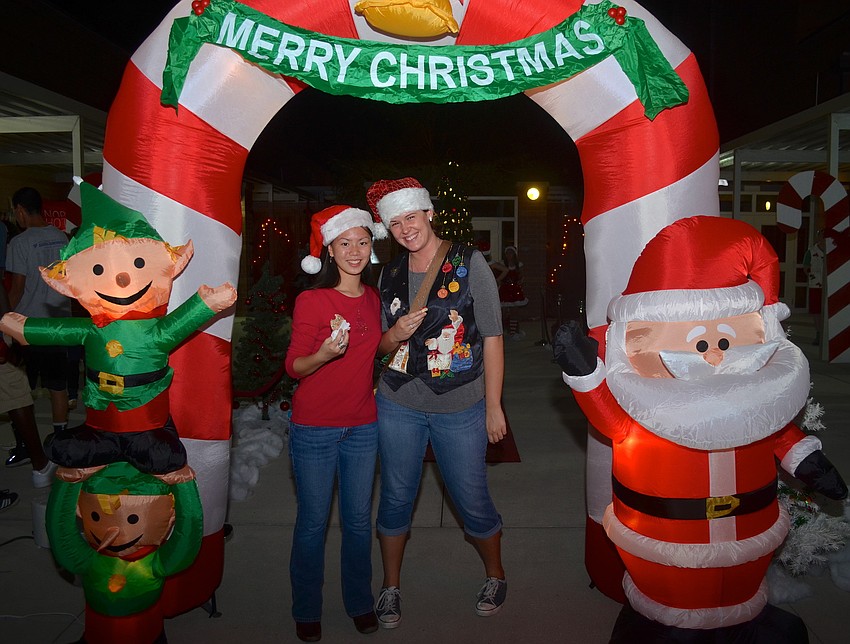 Sixteen-year-olds Alexa Hafley and Sierra Blashock pose near inflatable holiday figures.