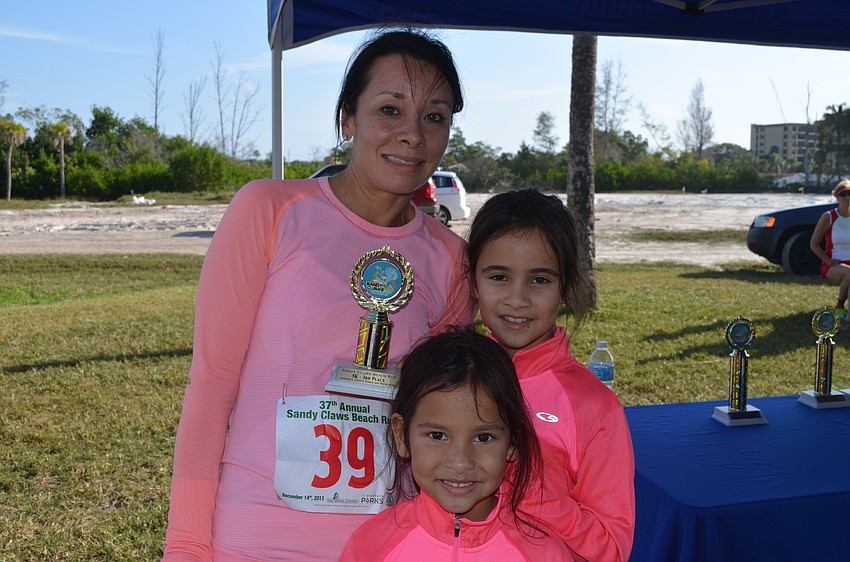 Stephanie Caradonna celebrates coming in third in her age group with daughters, Caroline and Gabrielle Cannon.