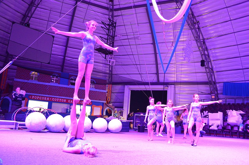 Sierra Pittman, 14, balances on Alli Pierce, 15.