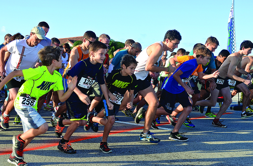Runners sprint from the starting line during Harvest United Methodist's Harvest Hustle 5K Nov. 23.