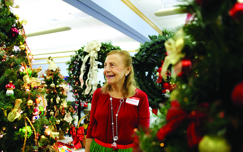 Vivian Leahy laughs as she turns on the lights of a Christmas tree Nov. 23, at the St. Mary, Star of the Sea, Catholic Church Christmas Bazaar.