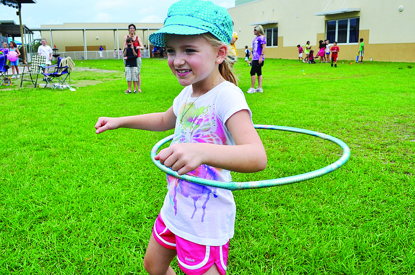 Maddie Hotaling hula-hoops June 7 during McNeal Elementary's field-day event.