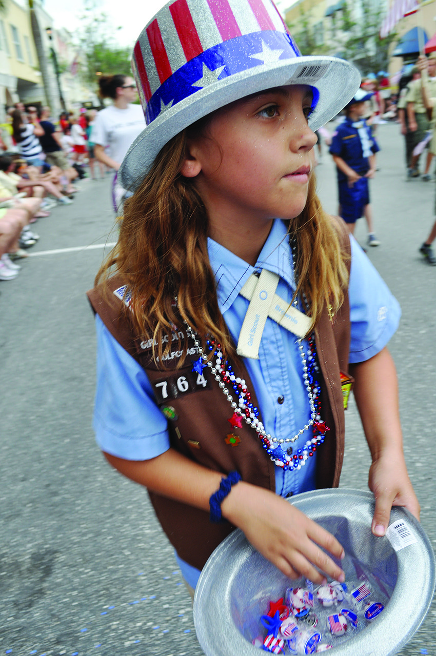 Willis Elementary School's Nicole Bastidas, 8, passes out candy during Lakewood Ranch Main Streetâ€™s Memorial Day parade May 26.