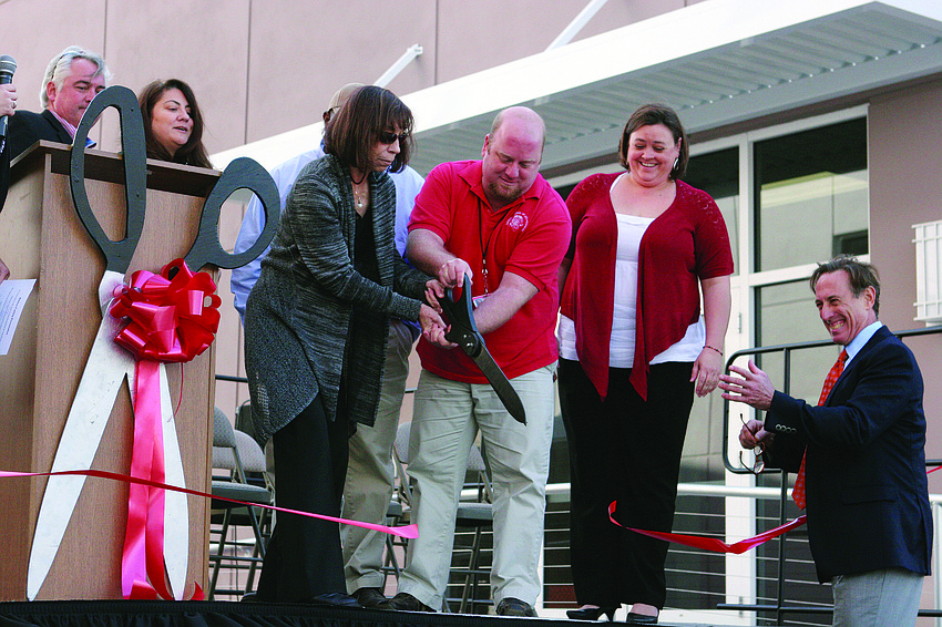 Marilyn Highland, Mickey Stone and Tanya Jones cut the ceremonial ribbon for the reconstruction of charter school Sarasota School of Arts and Sciences Jan. 22.