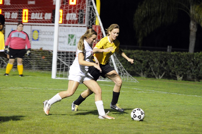 Cardinal Mooneyâ€™s Courtney Lynn and Booker Highâ€™s Joy Jux battle for possession during the first half of their Class 2A-District 11 semifinal match Jan. 14.