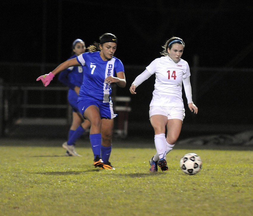 Cardinal Mooney senior defender Hanna Macdevitt sends the ball back up to the midfield.