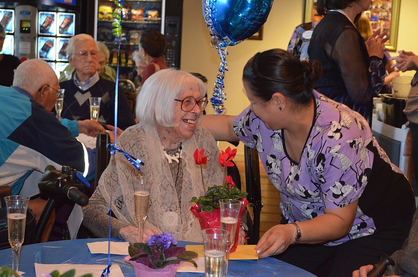 Yolanda Quistan gives Charlotte flowers. 