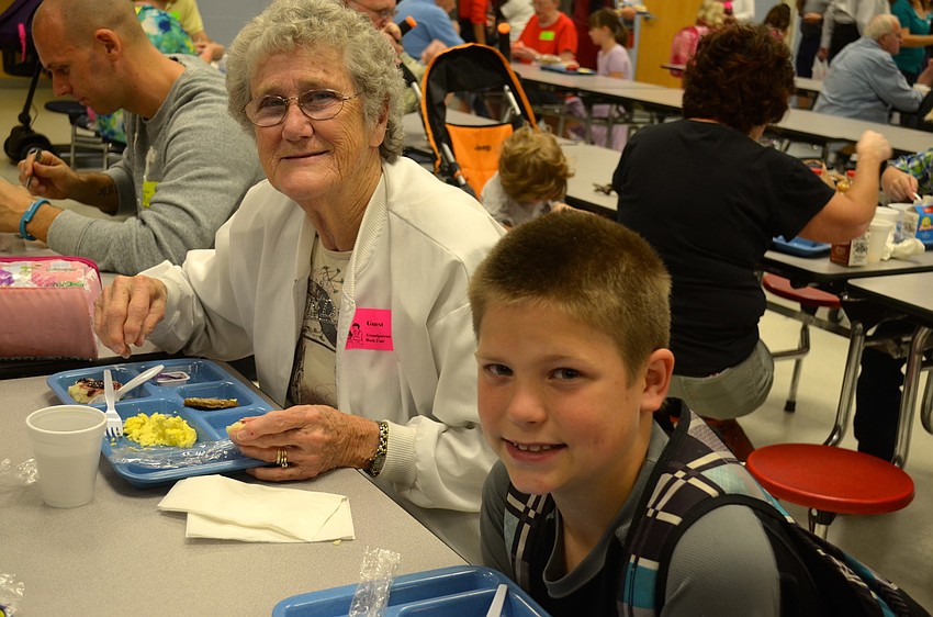 Carol Harvey enjoys an early meal with her grandson Kurt, 10.