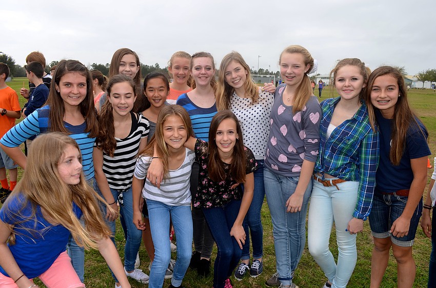 Eighth-grade girls take time away from walking and pose.