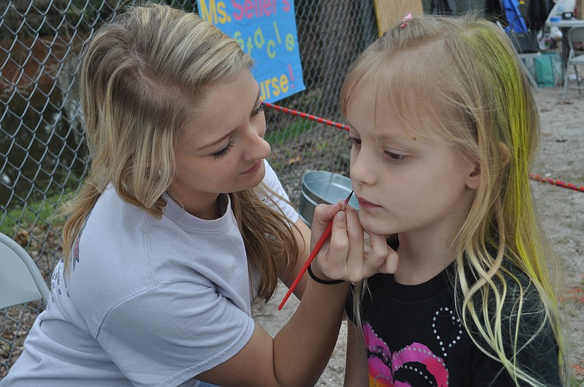 Volunteer Aimee Reagan painted the face of first grader Ashley DeJarnette