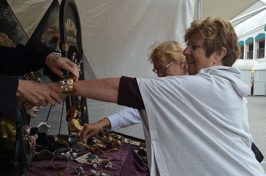 Kathy Haley tries on a bangle watch before buying it.
