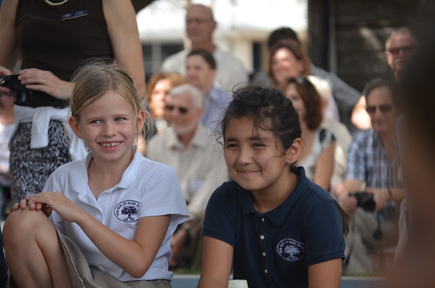 Katy F. and Sara C. watch from the sidelines.