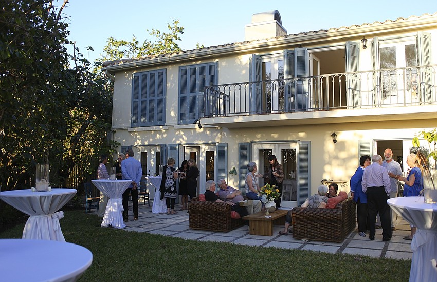 Guests enjoy cocktails and hors dâ€™oeuvres on the patio.
