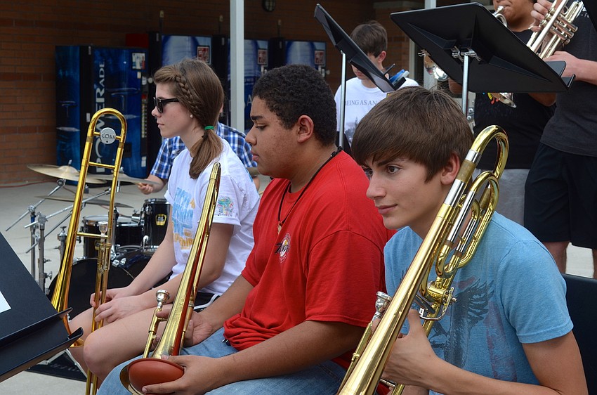 Caylynn Pigott, 16, Daniel Mach-Holt, 16, and Alex Ruiztagle, 15, wait for their turn to play.