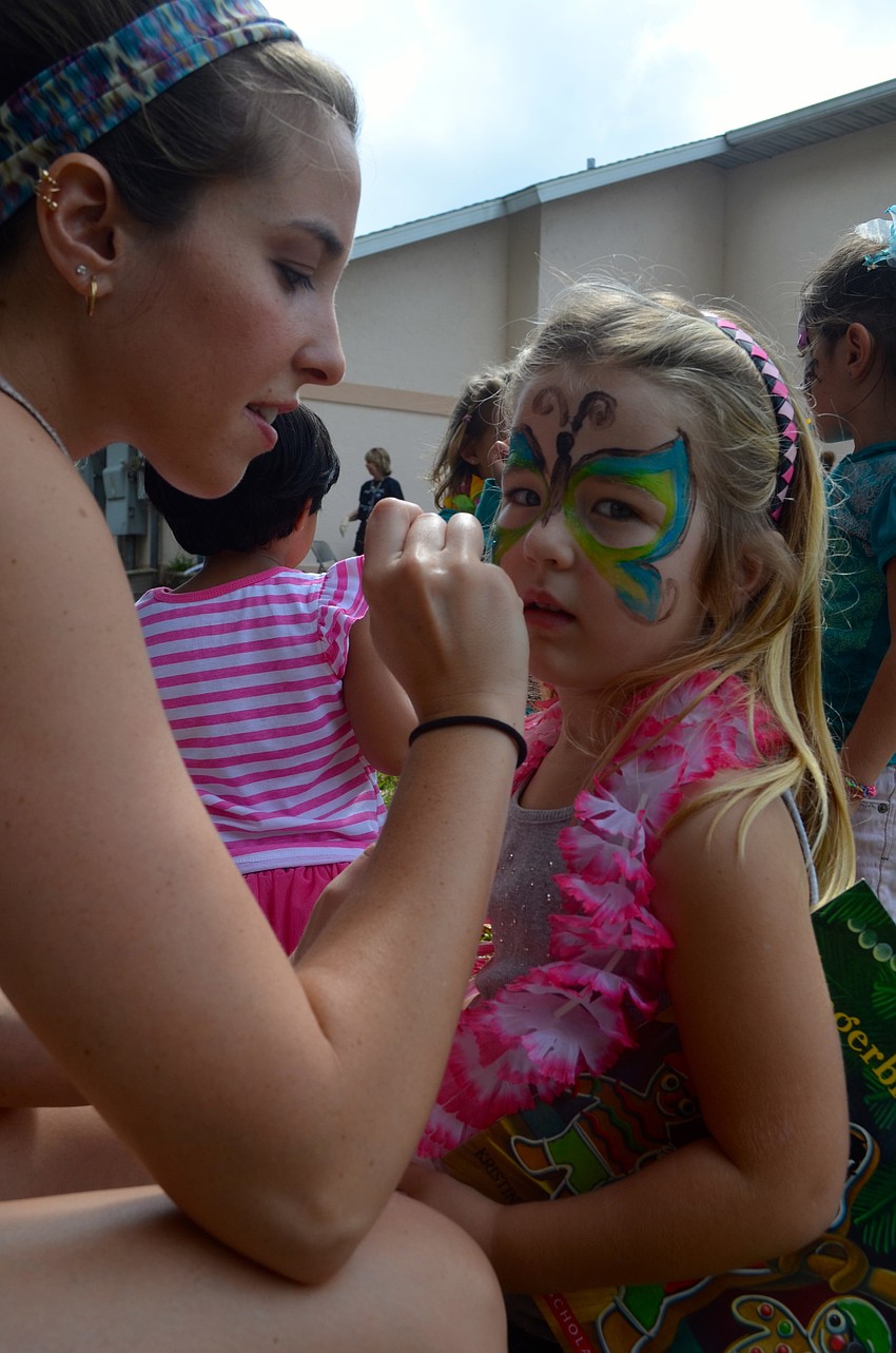 Cara Pogan turns Mya Brauch, 5, into a butterfly.