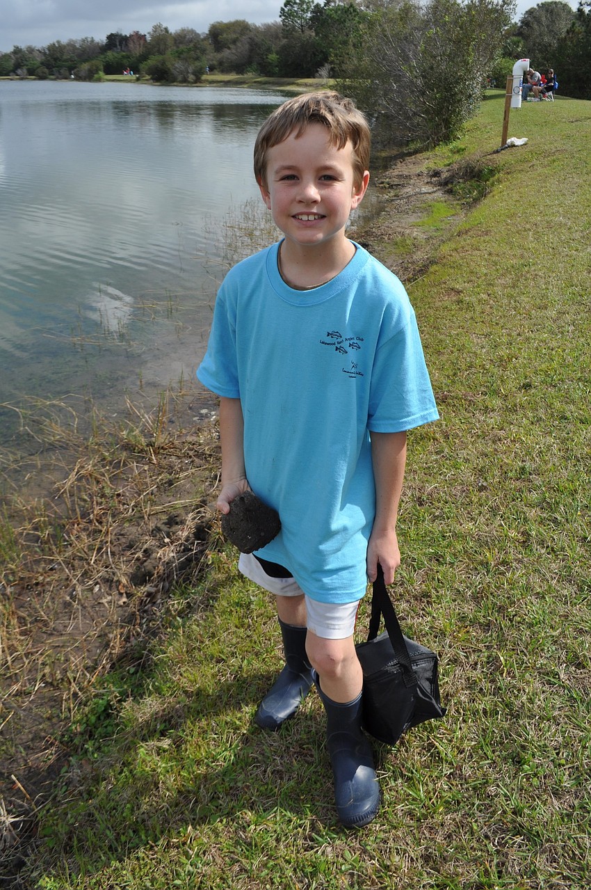 Brody Leiberick wades into the water to fish.