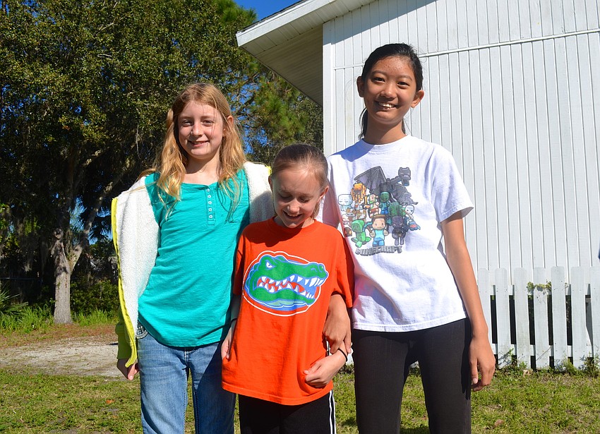 Hannah O'Neill, 10, Autumn Hoefle, 10, and Jenna Sun, 11, take a break.