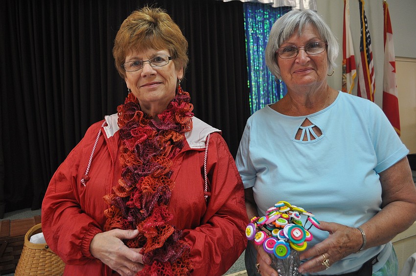 Diane Childs showed off her knitted scarves with Pat Allen, who crafted flowers out of buttons.