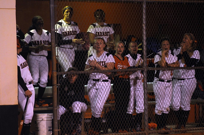 The Sarasota High dugout cheers on one of its batters during the bottom of the first inning.