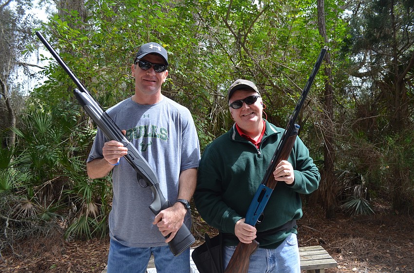 Russ Robbitt and Jamie Purmort, of Purmort and Martin Insurance, with their Beretta 12 gauge shotguns.