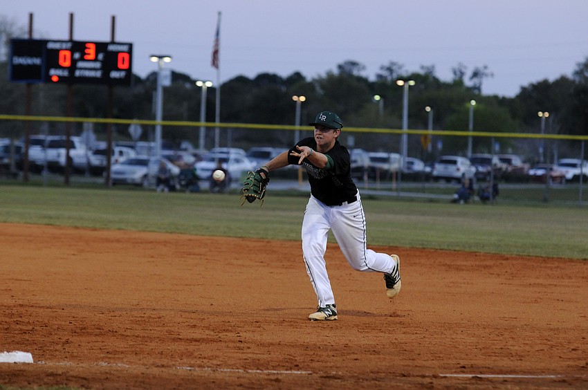 Lakewood Ranchâ€™s Colton Chupp flips the ball back to first base to record an out for the Mustangs.