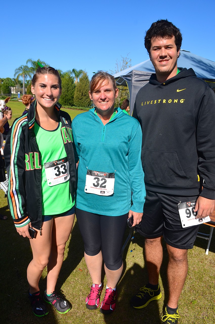 Alex Barr, Billie Farris and Greg VanOekel relax after the 5K run.