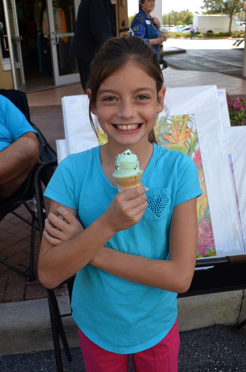 Nine-year-old Shaela Runkle enjoys a cold treat on a warm day.