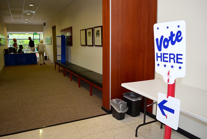 Voters are greeted at the door before entering the polls.