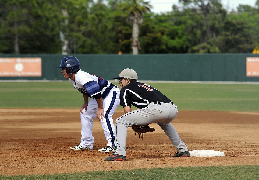 Sarasota High first baseman Mason Dancer looks to keep a Florida Christian base runner from stealing second base.